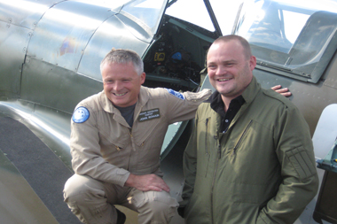 Comedian Al Murray and John Romain (Aircraft Restoration Company) with two-seat Supermarine Spitfire at Duxford